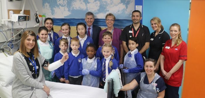 Longfleet Road School teacher and schoolchildren, together with David Moss, chairman and Debbie Fleming, chief executive, (both back centre), and other members of hospital staff, at the opening of the new facility
